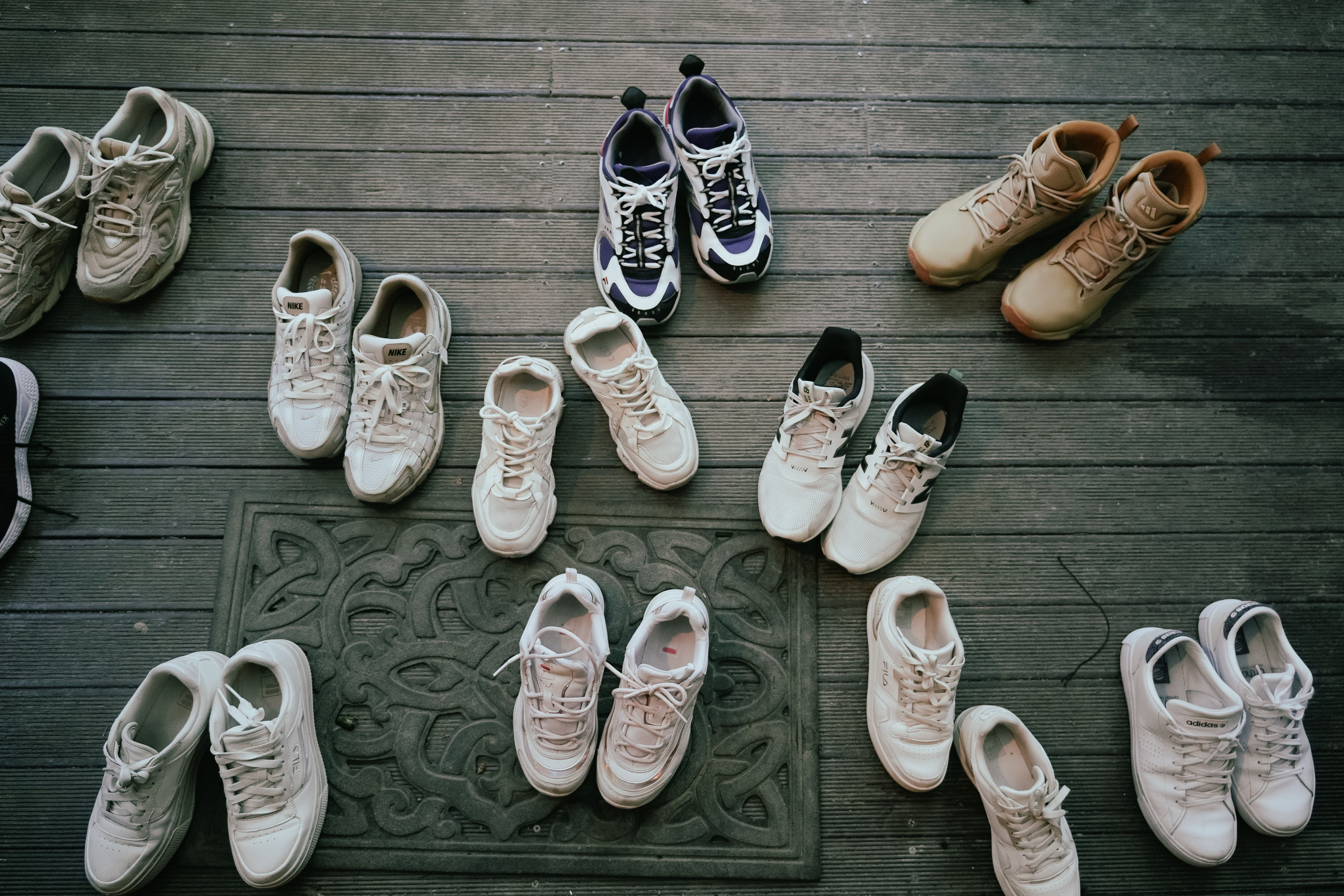 various athletic and casual sneakers arranged on a clean background - Comfortable travel shoes