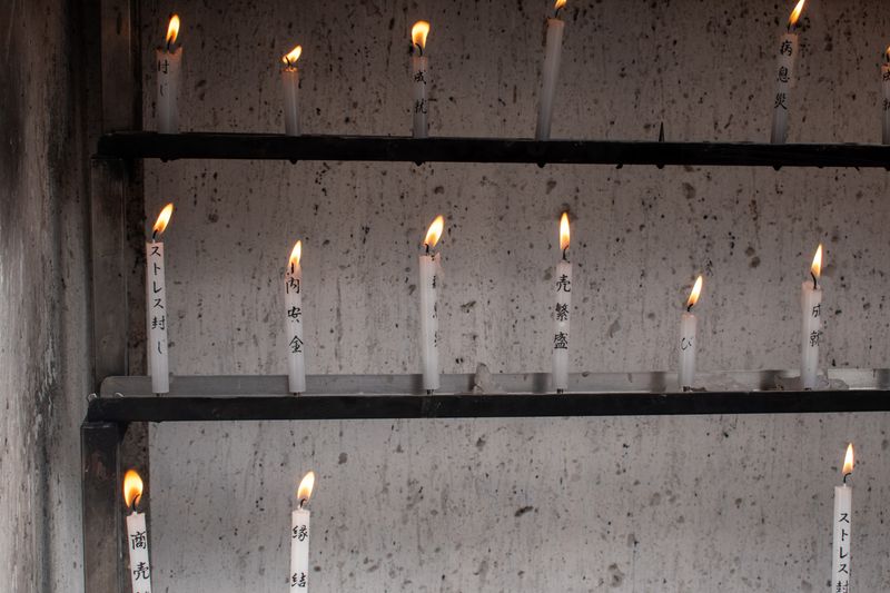 Prayer candles on display in a shrine in Kyoto, symbolizing peace and hope.