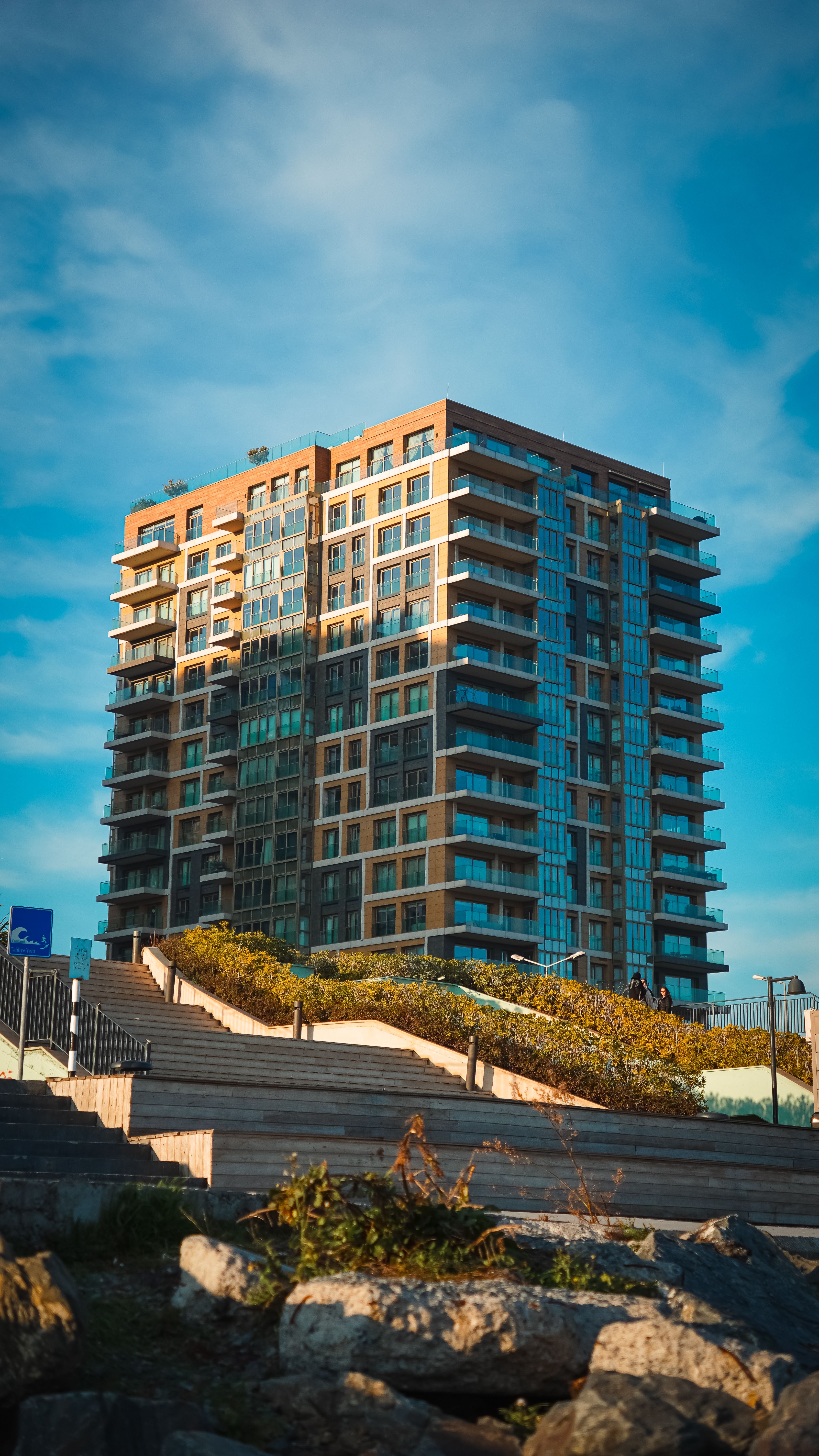 Contemporary high-rise building in Istanbul, under a bright blue sky.