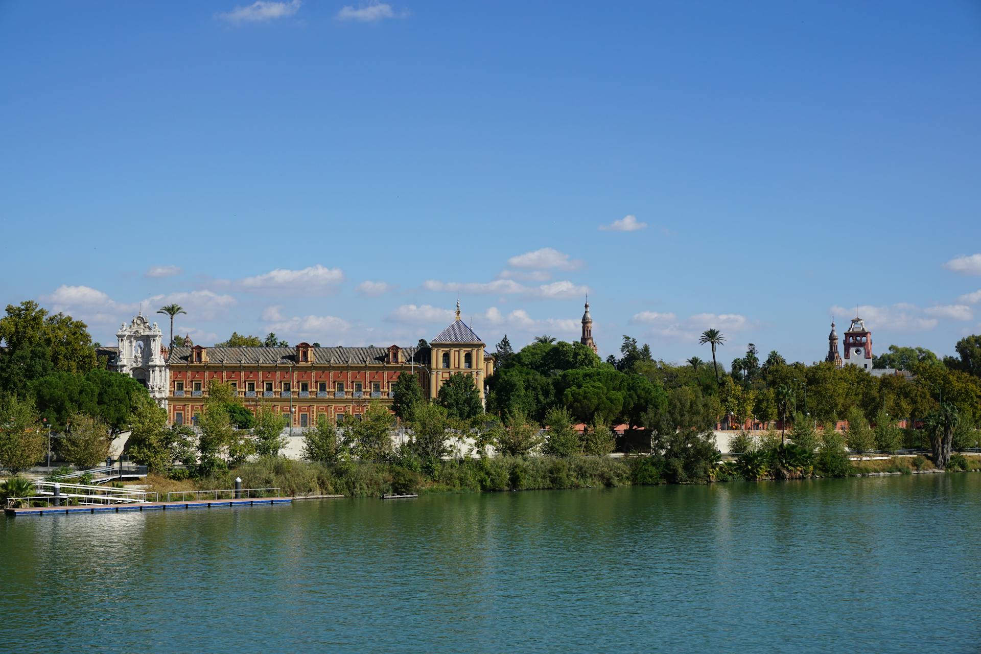 Scenic view of historic buildings by the riverside in Seville, Spain.