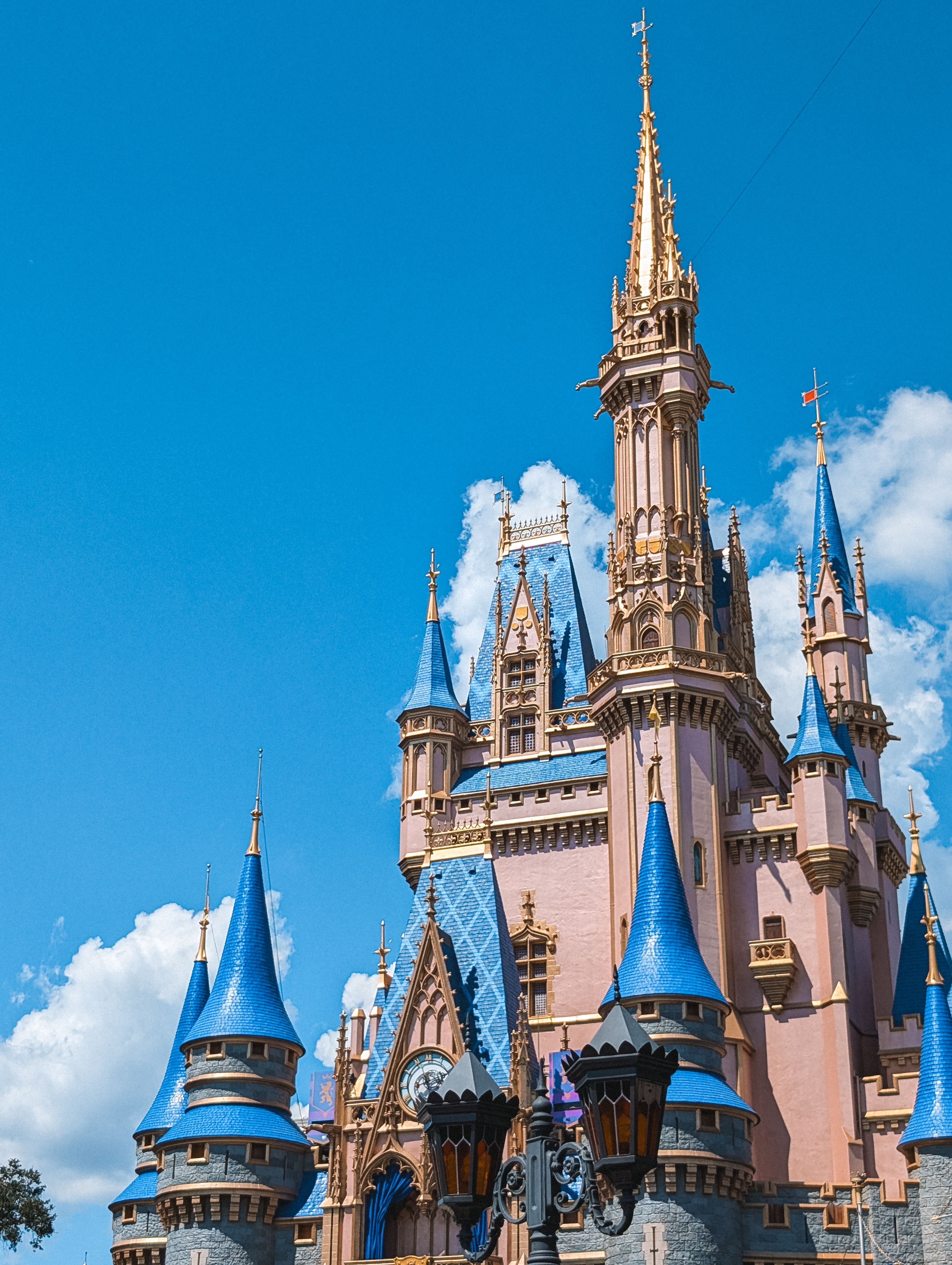 Captivating shot of Cinderella Castle's intricate architecture under a bright blue sky.