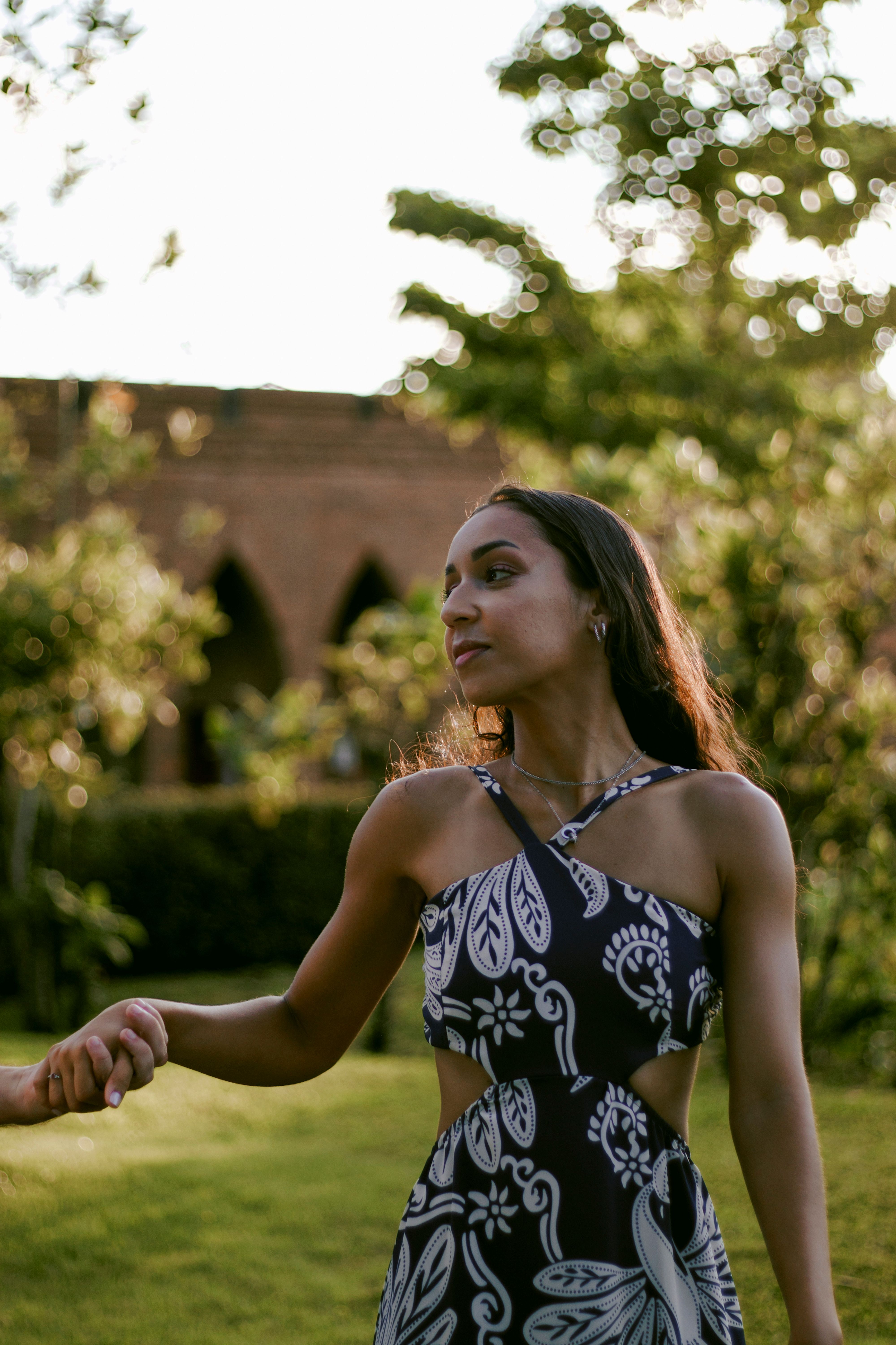 Outdoor Portrait of Woman in Floral Dress at Sunset · Free Stock Photo