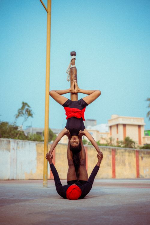 Free Dynamic mallakhamb duo showcasing incredible balance and teamwork outdoors. Stock Photo