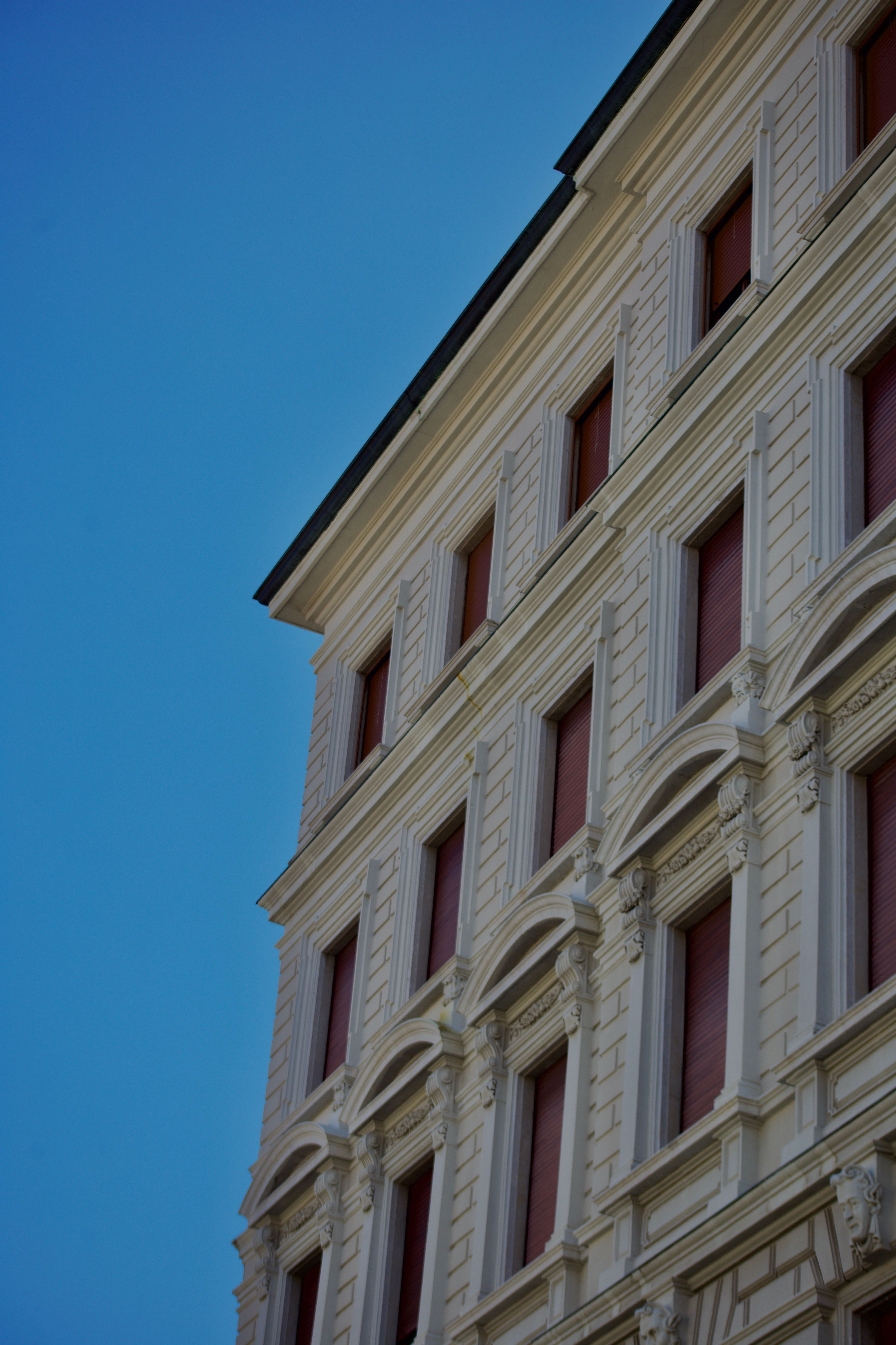 Elegant architectural facade of a historic building under a clear blue sky.