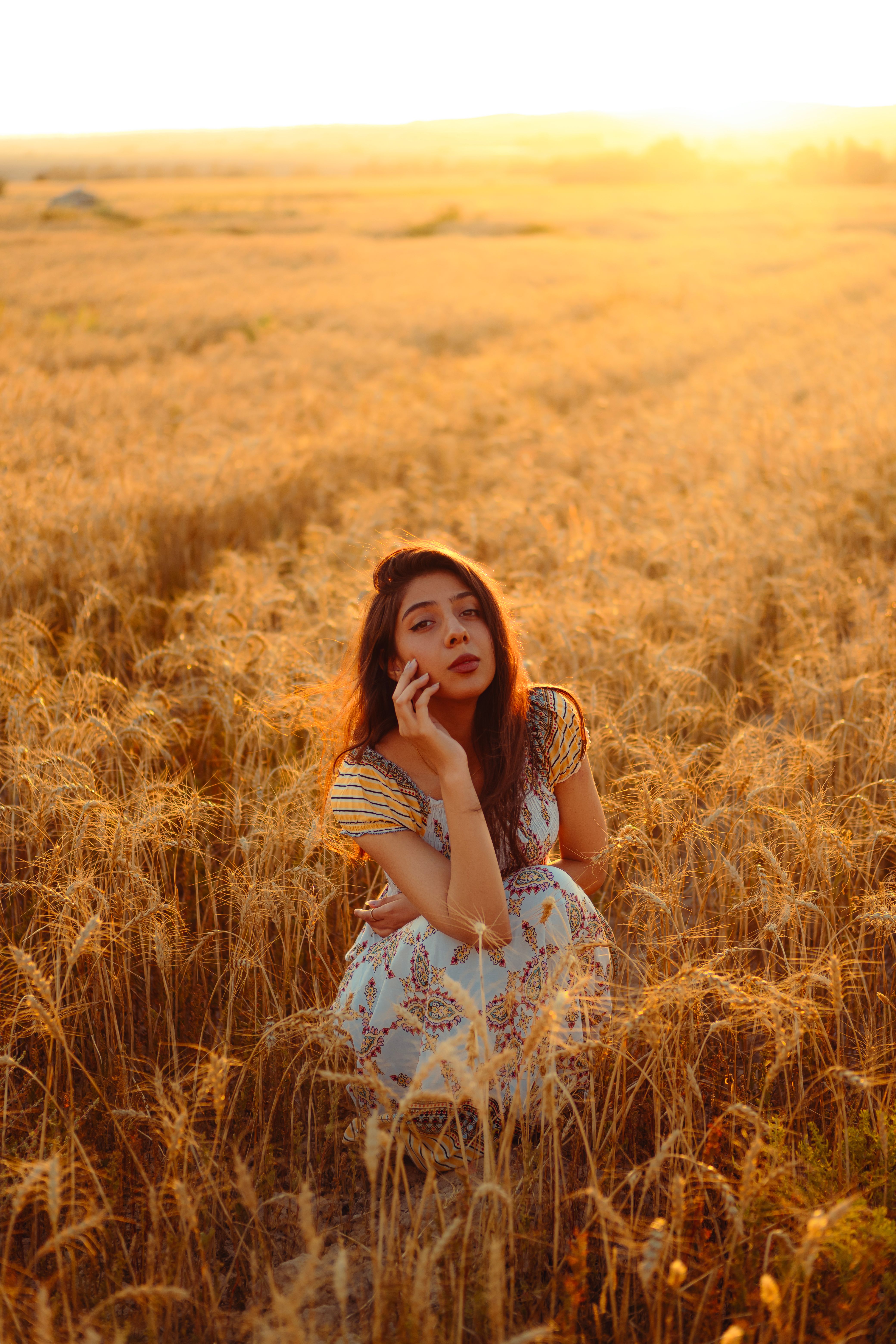 Woman in Wheat Field During Golden Hour · Free Stock Photo