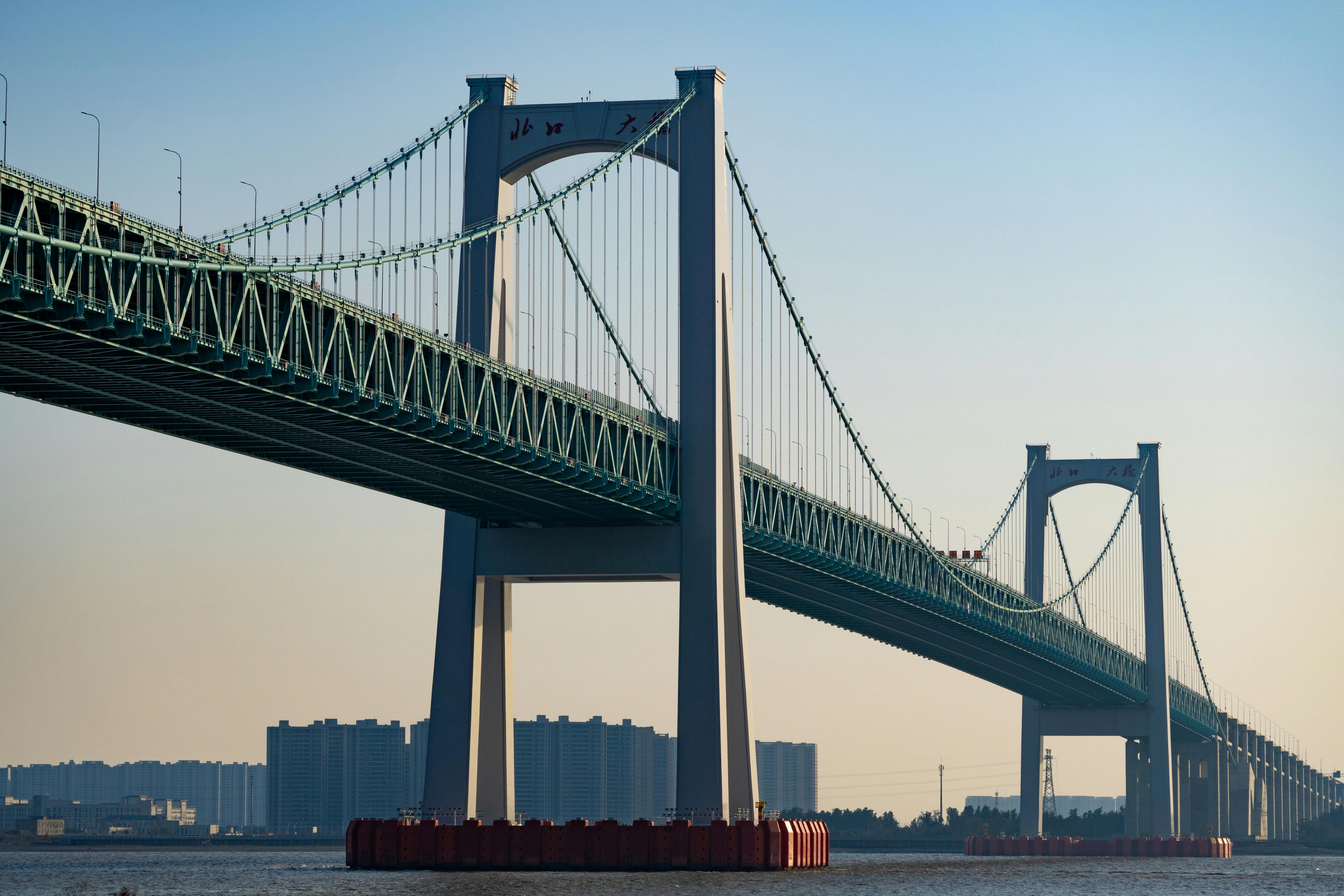 majestic suspension bridge spanning the river at dusk