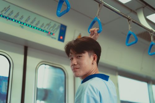 Free Young man traveling in the Ho Chi Minh City metro system, capturing urban lifestyle. Stock Photo