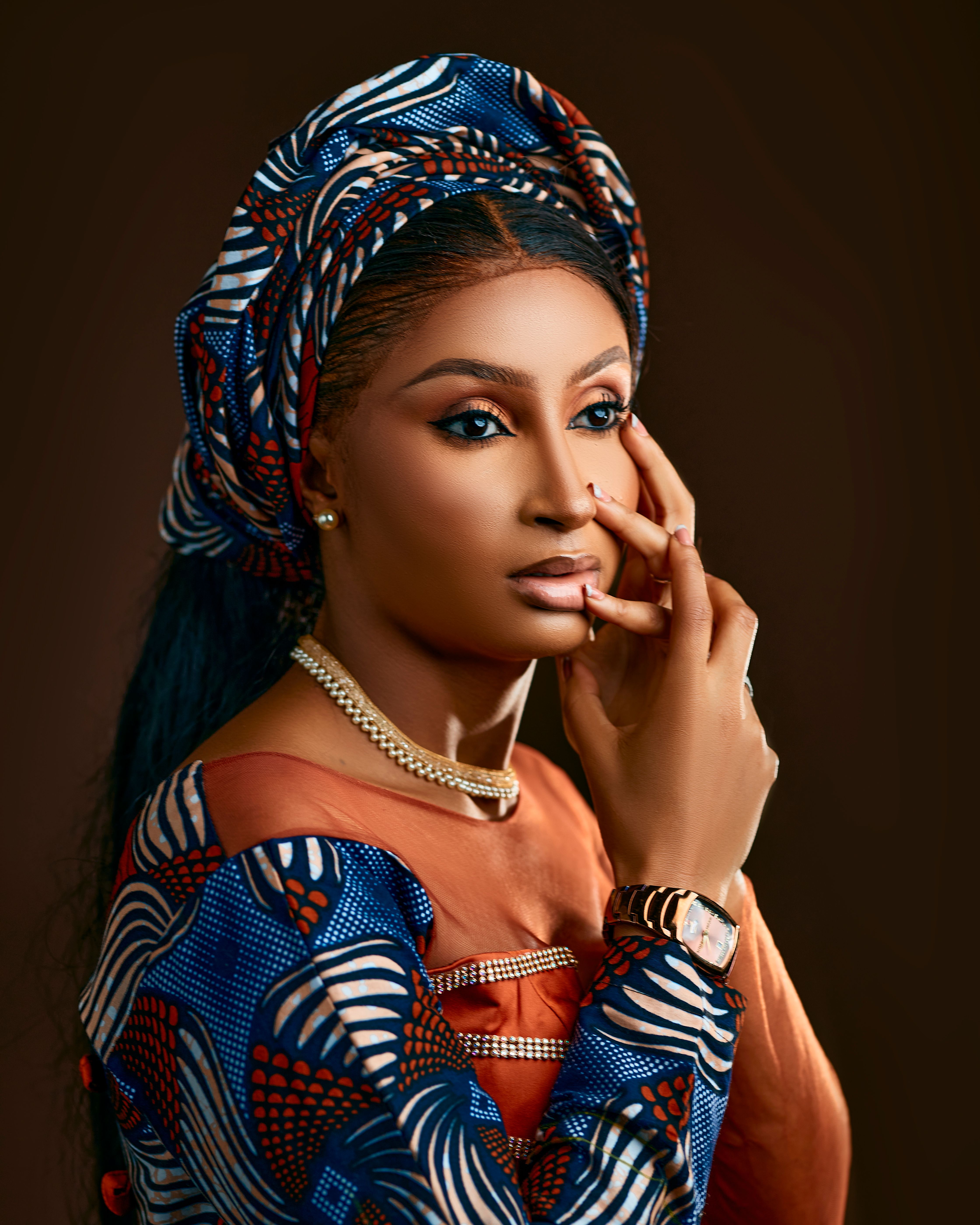 Portrait of an adult African woman wearing vibrant traditional clothing, showing grace and elegance.