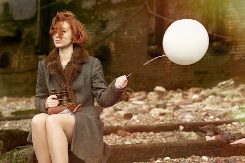 Woman Holding White Balloon