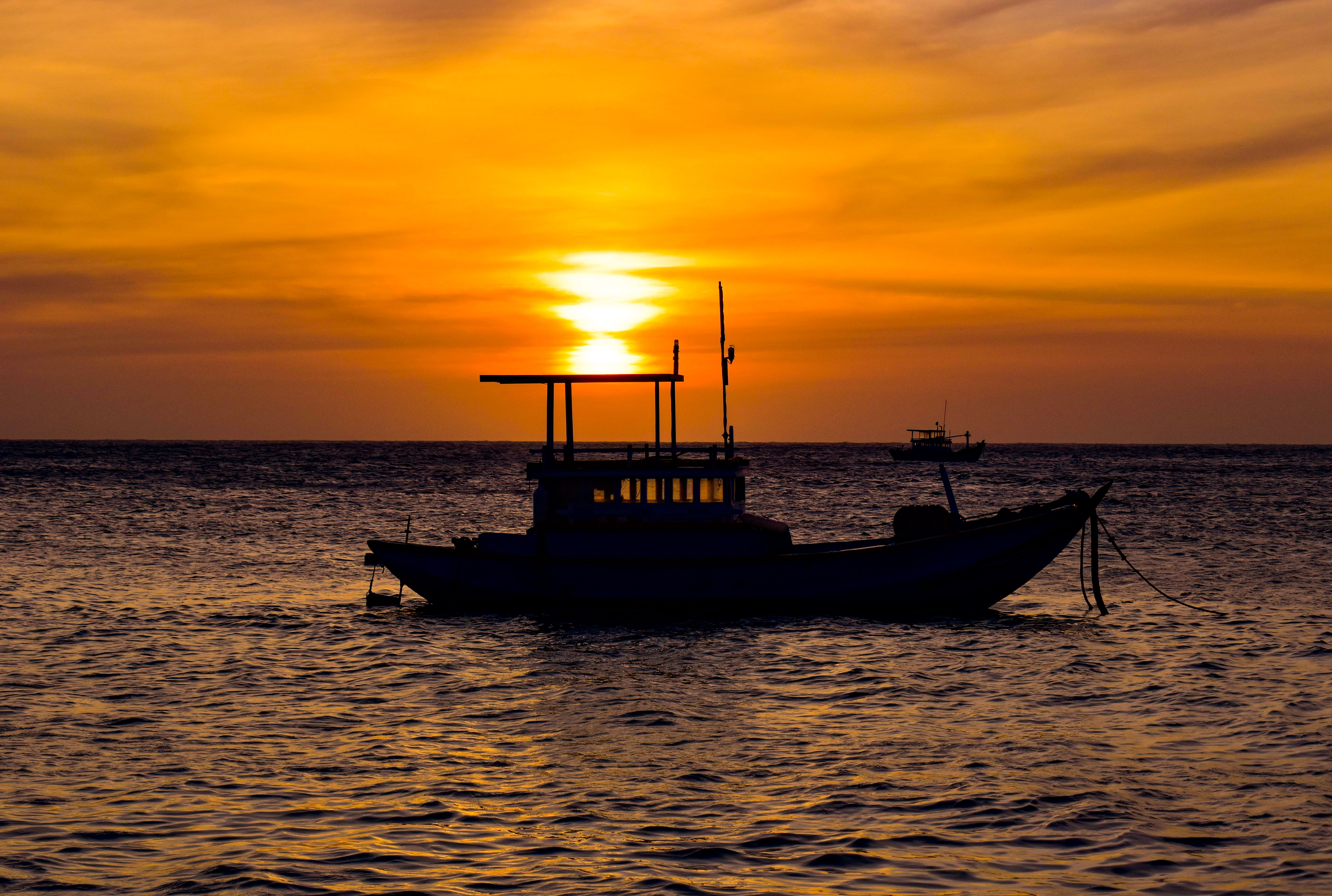 Silhouette of Fishing Boat at Sunrise · Free Stock Photo