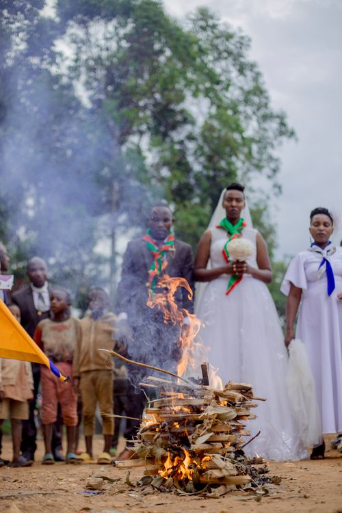 Free A vibrant traditional wedding ceremony with participants in cultural attire surrounding a ritual fire. Stock Photo