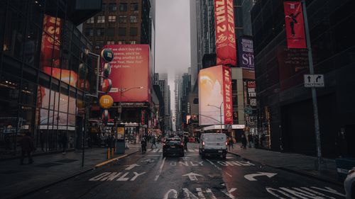 Free Dynamic city life at Times Square with illuminated signs and bustling streets in New York City. Stock Photo