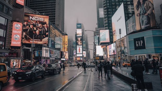 Rainy day in Times Square capturing lively urban atmosphere and vibrant billboards.