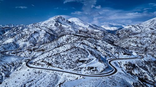 Free Majestic aerial view of snow-covered mountains in Turkey with winding road. Stock Photo