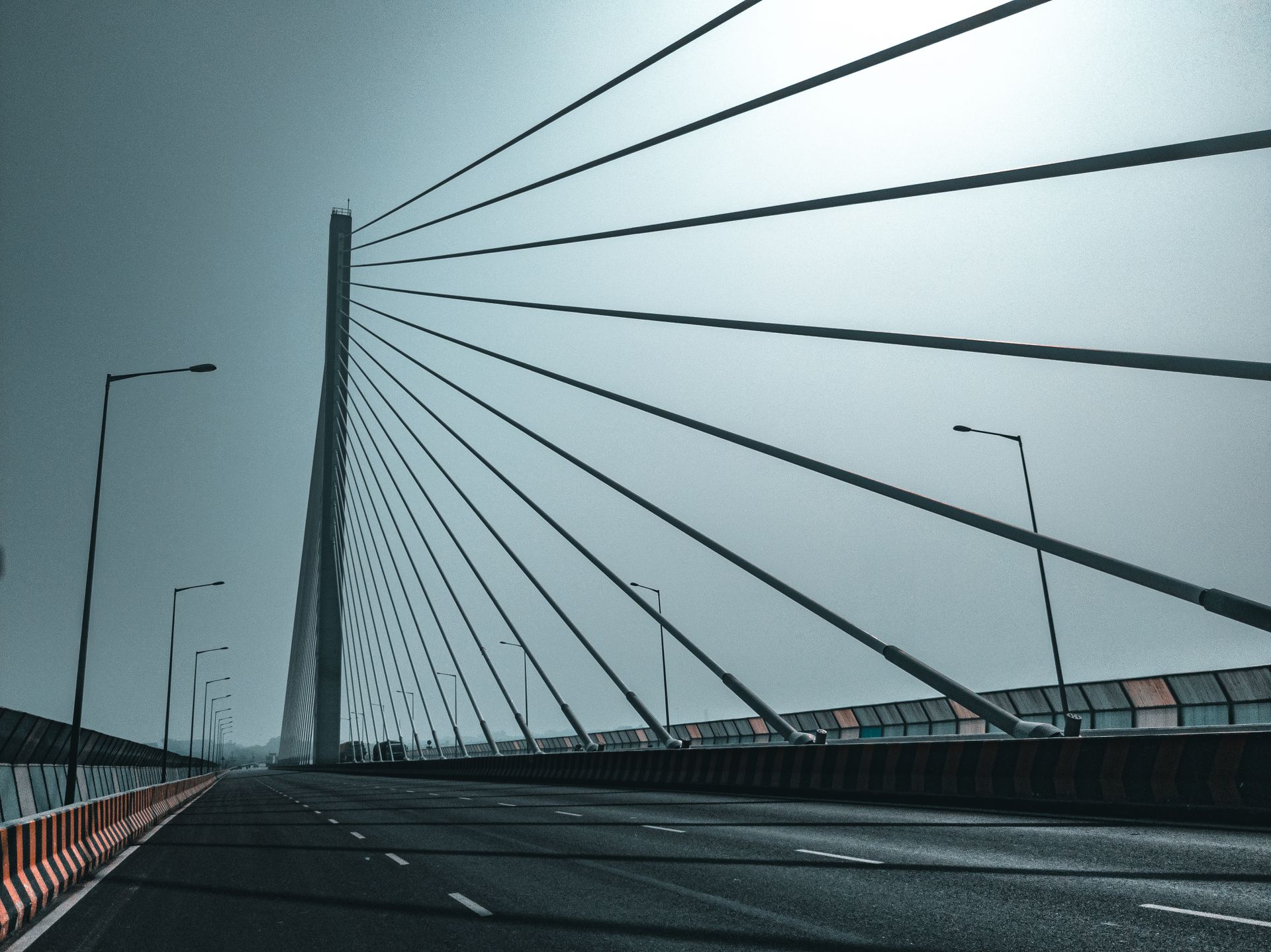 Dynamic view of a modern cable-stayed bridge in India with geometric cables and streetlights.