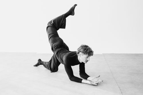 Free Black and white image of a dancer striking a dynamic pose indoors in Berlin. Stock Photo
