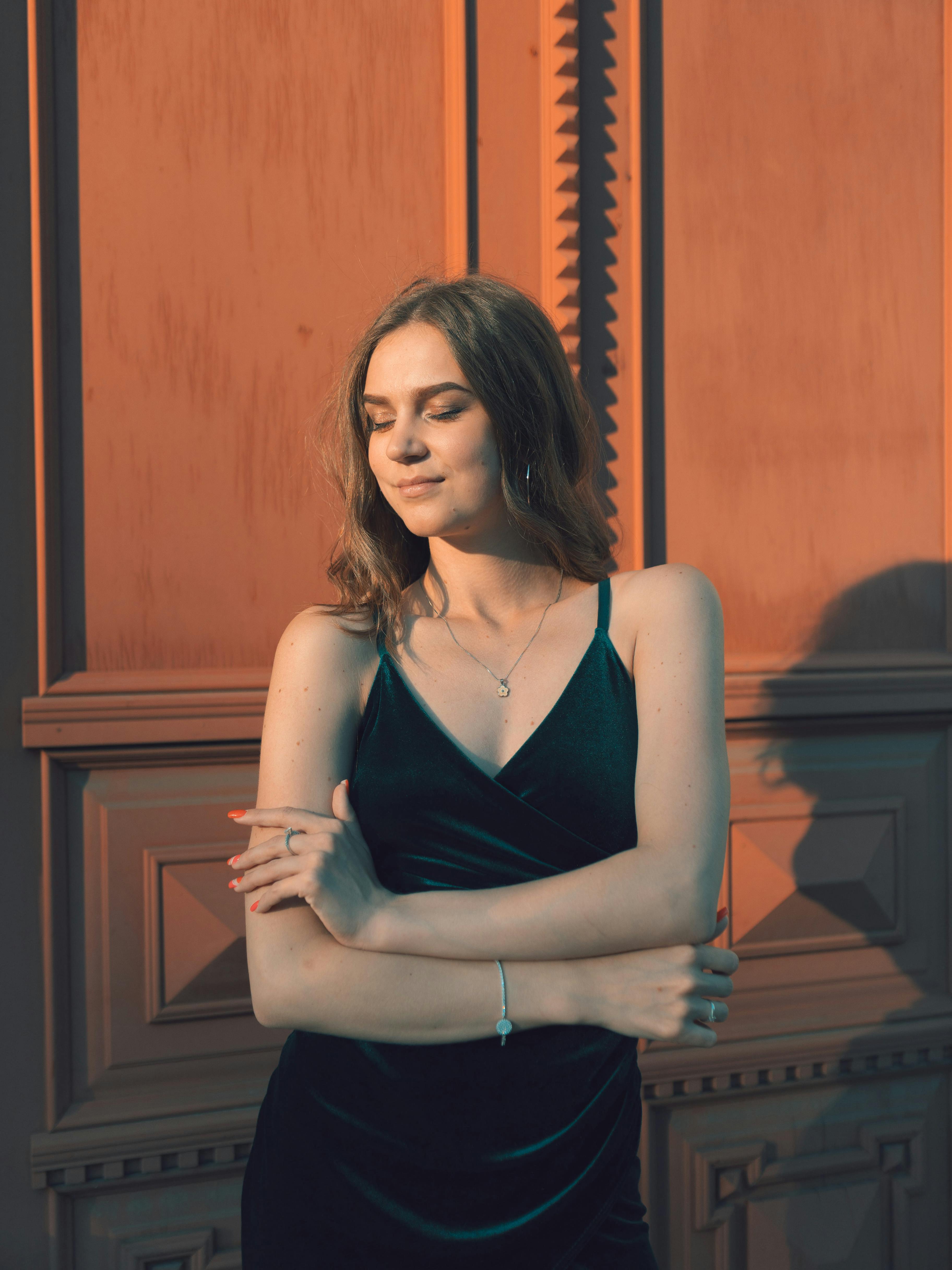 woman in a teal dress relaxing in. the sunlight