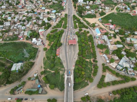 Aerial view of a busy urban intersection surrounded by greenery and residential areas in Malawi.