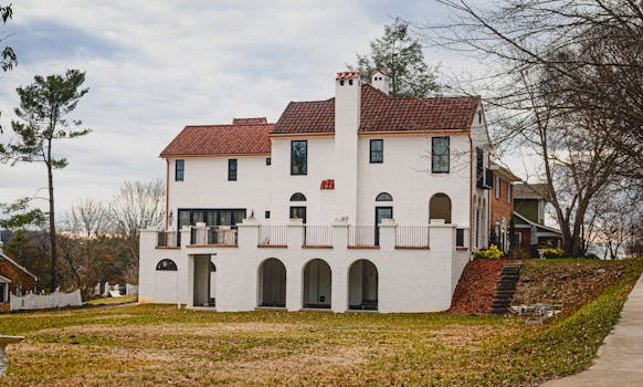 Spanish-style villa with arches and red tiled roofs in a serene suburban environment.