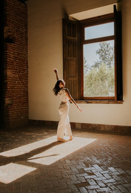 woman dancing in sunlit room