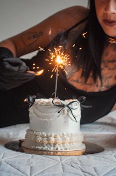 A close-up of a birthday cake with a sparkler lit on top, creating a festive ambiance.