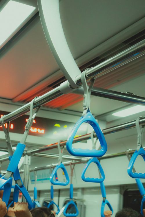 Free Blue handrails inside a crowded Ho Chi Minh City metro, vibrant urban scene. Stock Photo