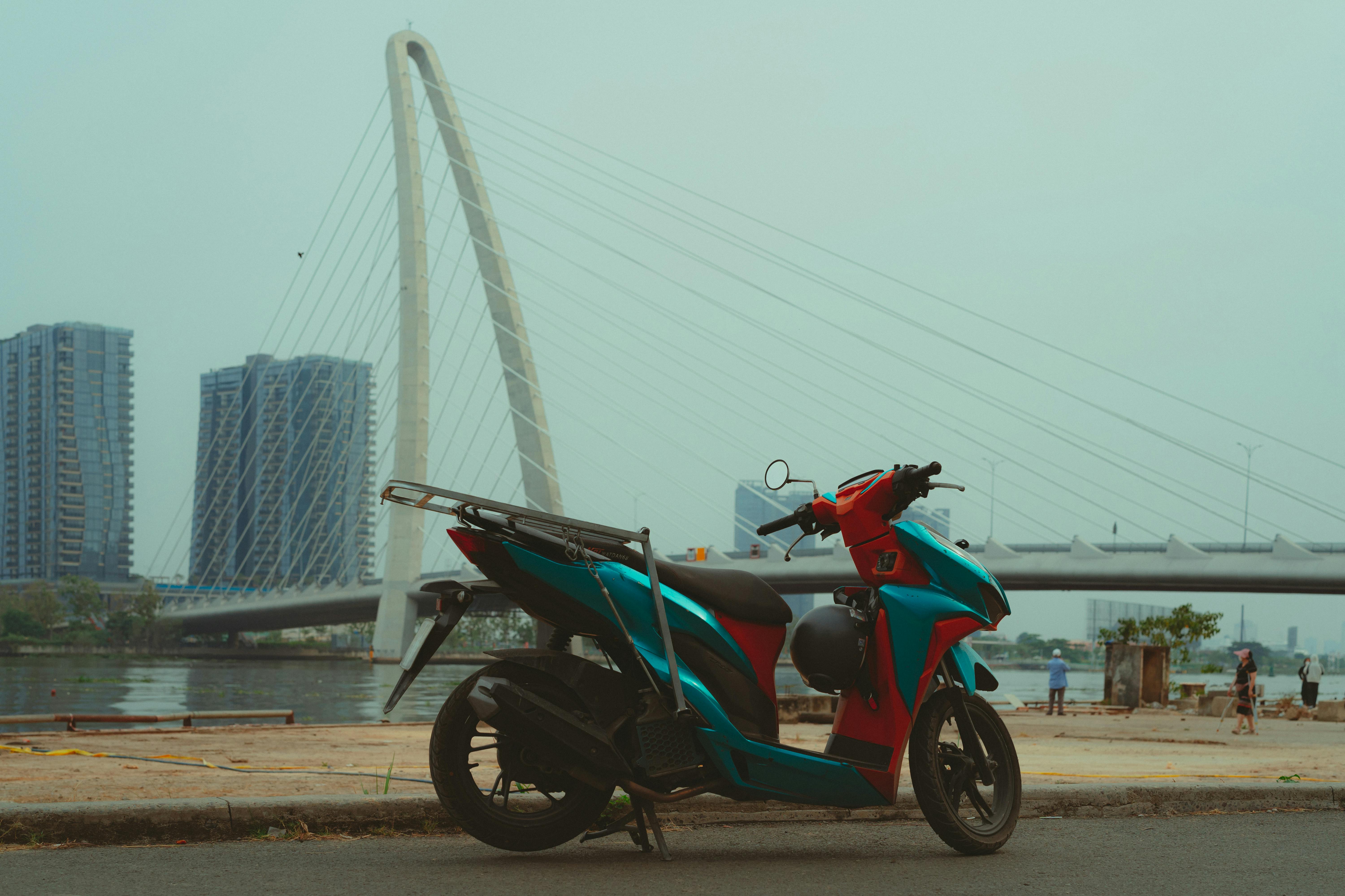 colorful motorcycle by landmark bridge in ho chi minh city