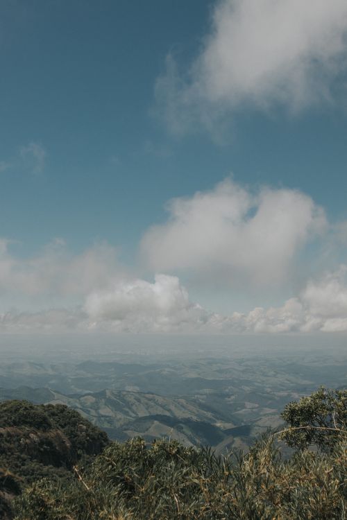 Free Stunning mountain landscape with rolling hills and a cloudy sky, offering an expansive view. Stock Photo