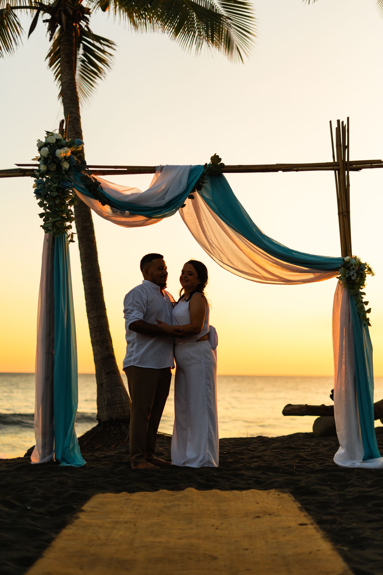 Outdoor destination beach wedding at sunset