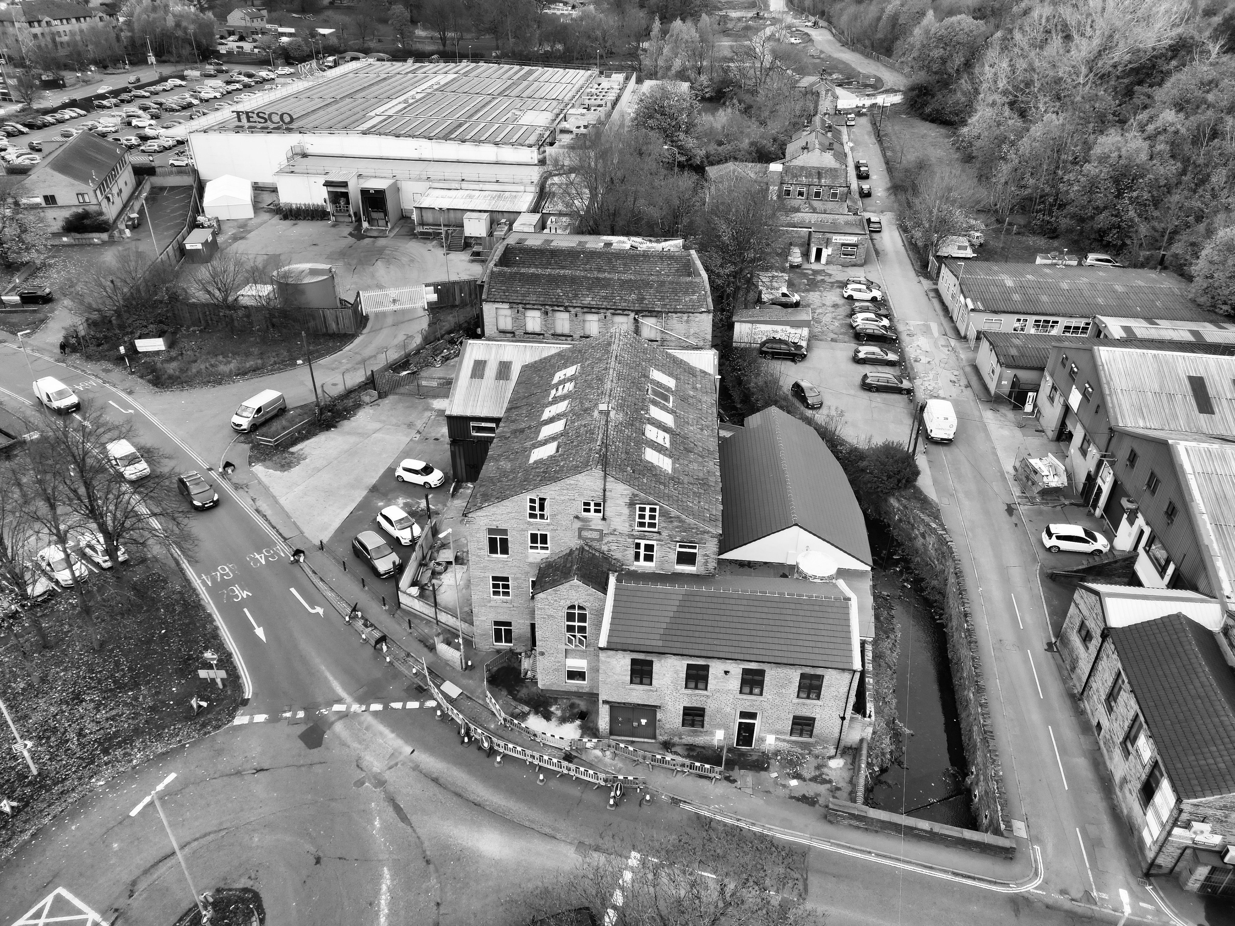 Aerial shot of an industrial region with warehouses and roads in monochrome.