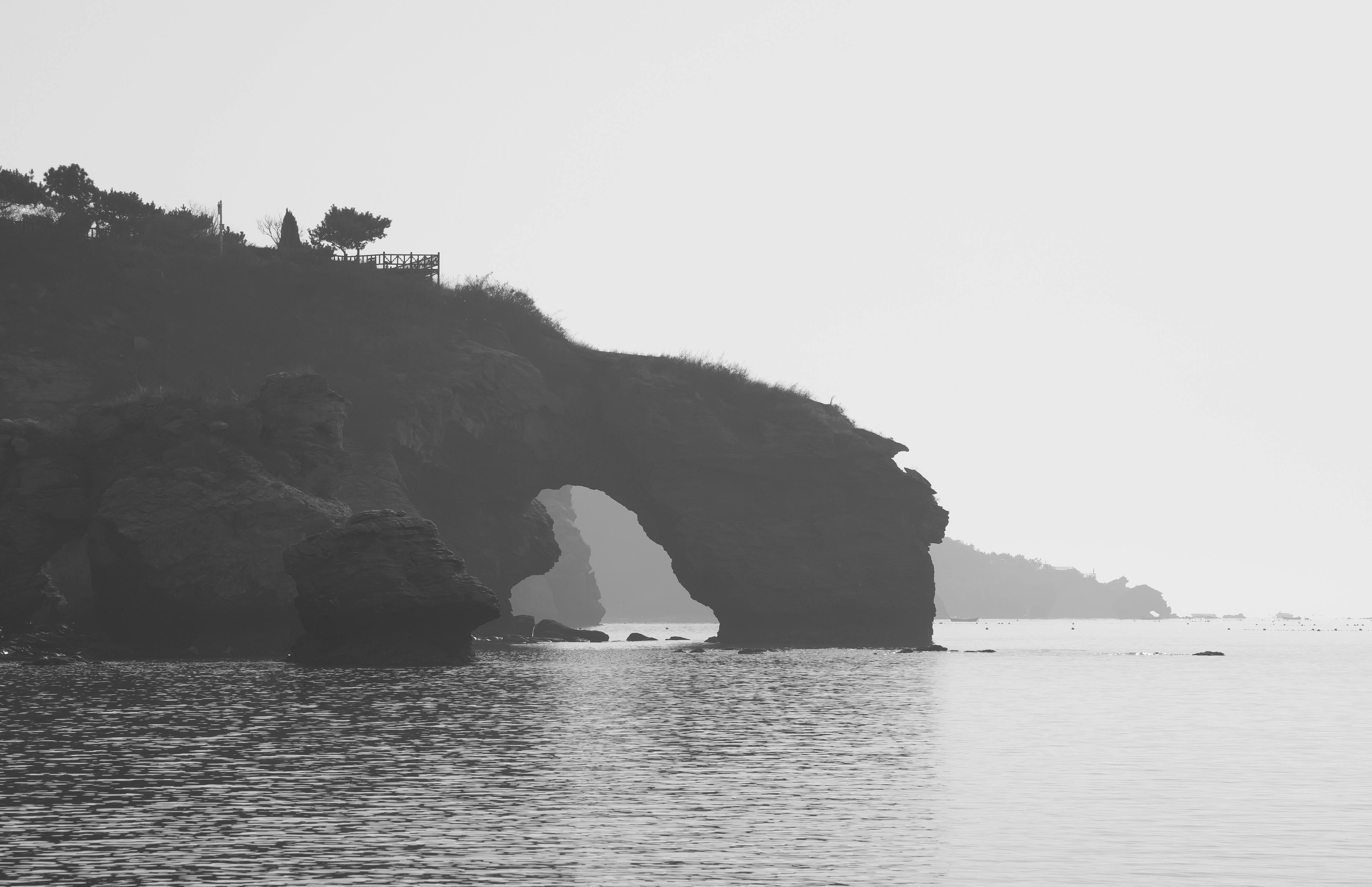 dramatic seaside cliff with natural arch in china