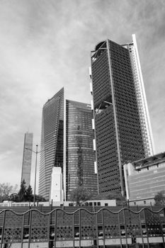 Black and white photo of Mexico City's modern skyscrapers, highlighting urban architecture.