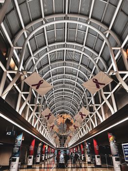 Explore the contemporary design of an airport terminal with vaulted ceilings and intricate metalwork.