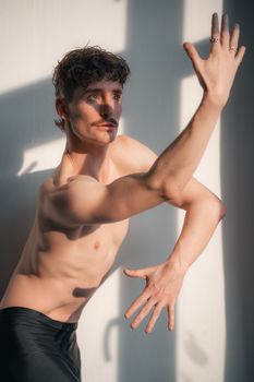 A young male dancer in Berlin striking a contemporary and expressive pose, showcasing natural beauty and creativity.