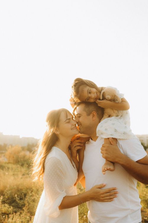 Free A joyful family moment outdoors with a warm and sunny ambiance. Stock Photo