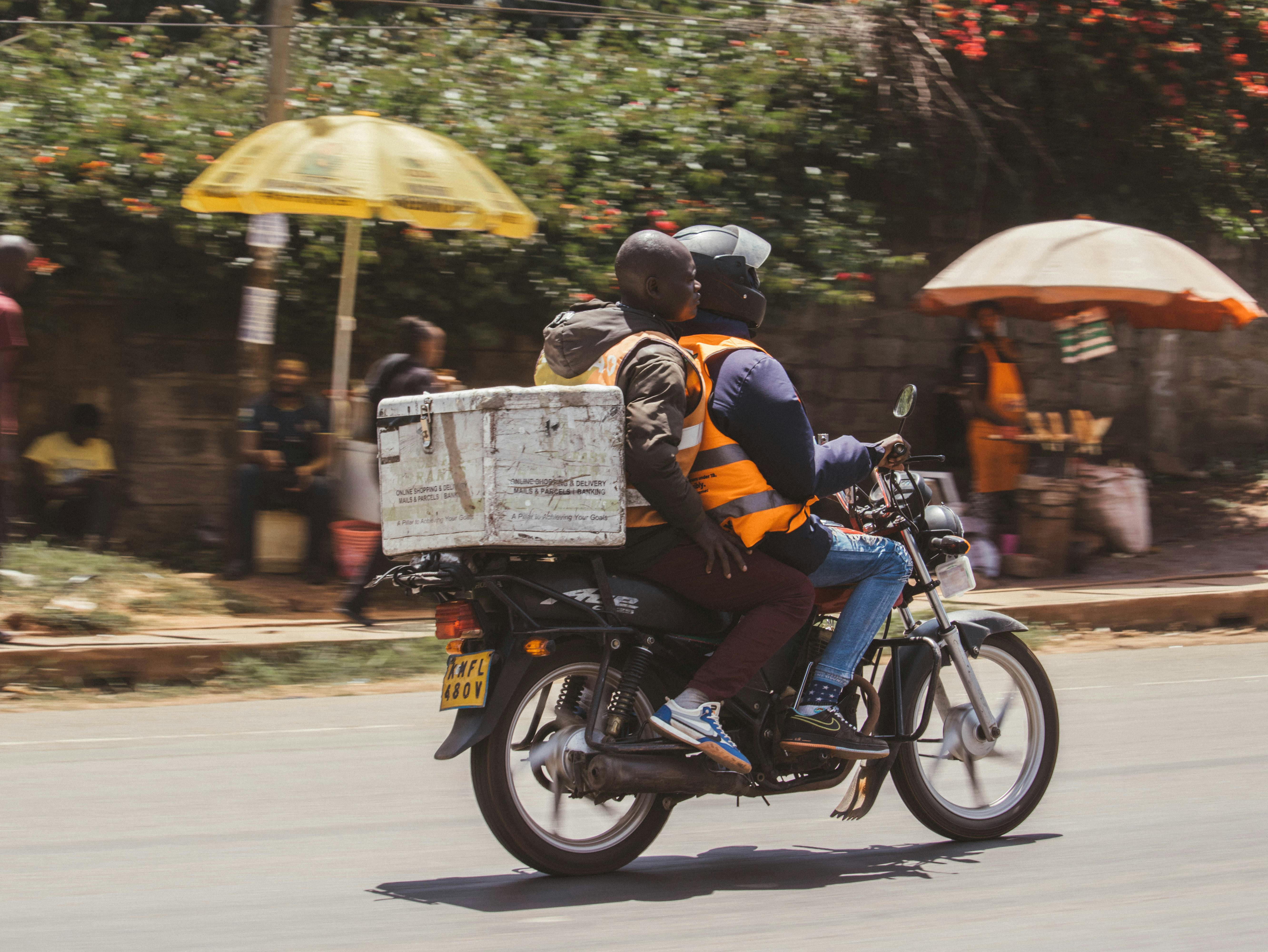 Motorcycle delivery rider moving through a city street