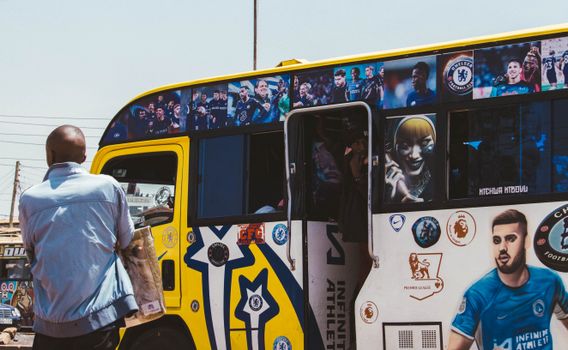 A vibrant matatu bus adorned with football artwork in Nairobi, Kenya, showcasing local culture and sports enthusiasm.