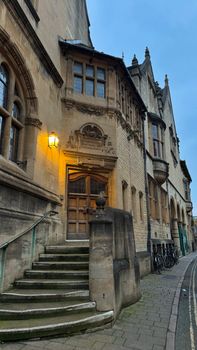 Charming historic building in Oxford, UK, illuminated at dusk.