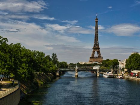 Scenic view of the Eiffel Tower and Seine River in Paris, captured on a sunny day.