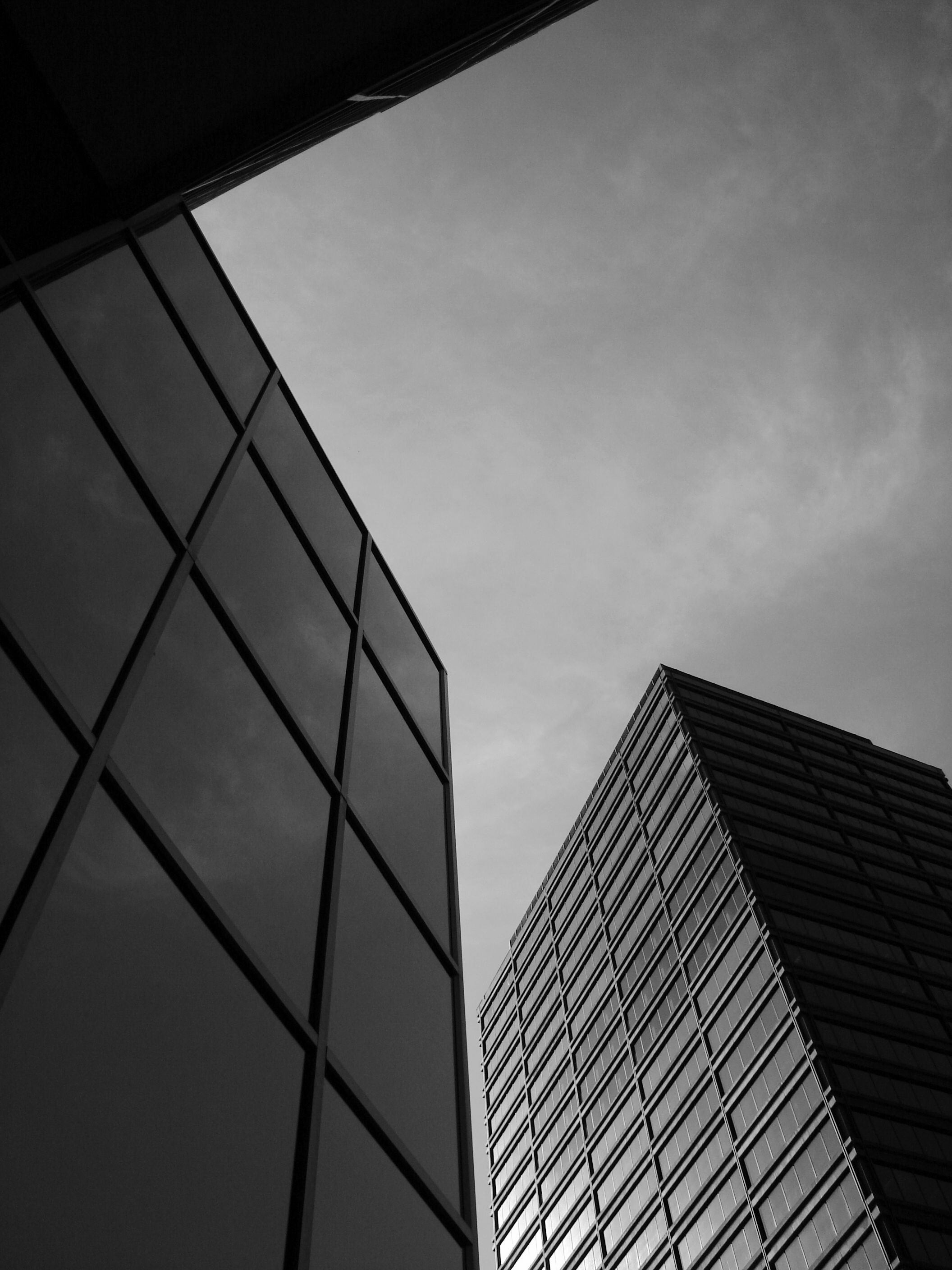 Modern Architectural Skyscrapers Against Cloudy Sky · Free Stock Photo