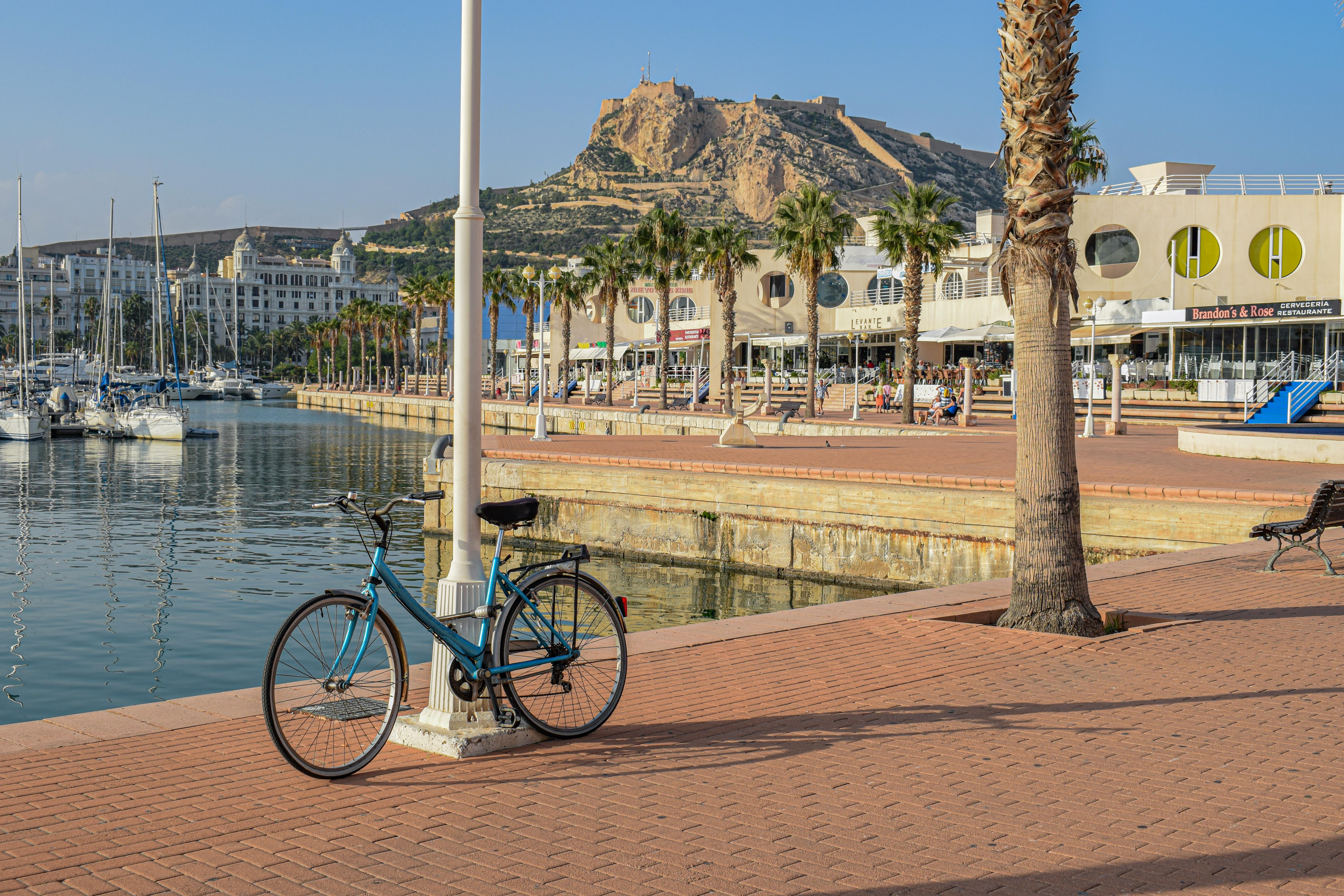 A scenic view of Alicante Marina with Santa Bárbara Castle in the background.