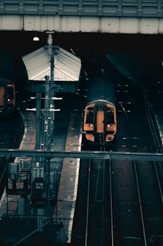 Capture of a moody train station in Edinburgh during nighttime with dim lighting.