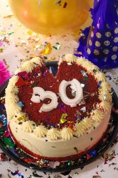 Colorful 30th birthday celebration with a red velvet cake and party decorations.