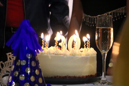 30th birthday cake with candles and champagne for a festive celebration.
