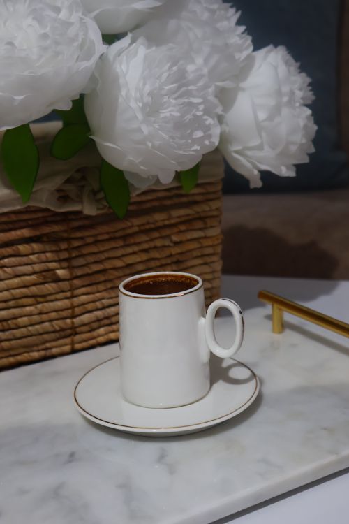 Free Small coffee cup on marble tray with basket and flowers. Stock Photo
