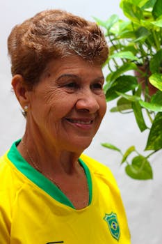 Portrait of a smiling elderly woman wearing a Brazil soccer jersey, set in São Paulo.
