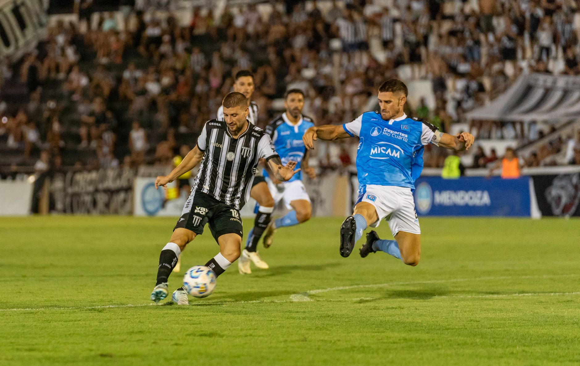 Exciting moment during a professional soccer match with players competing for the ball.