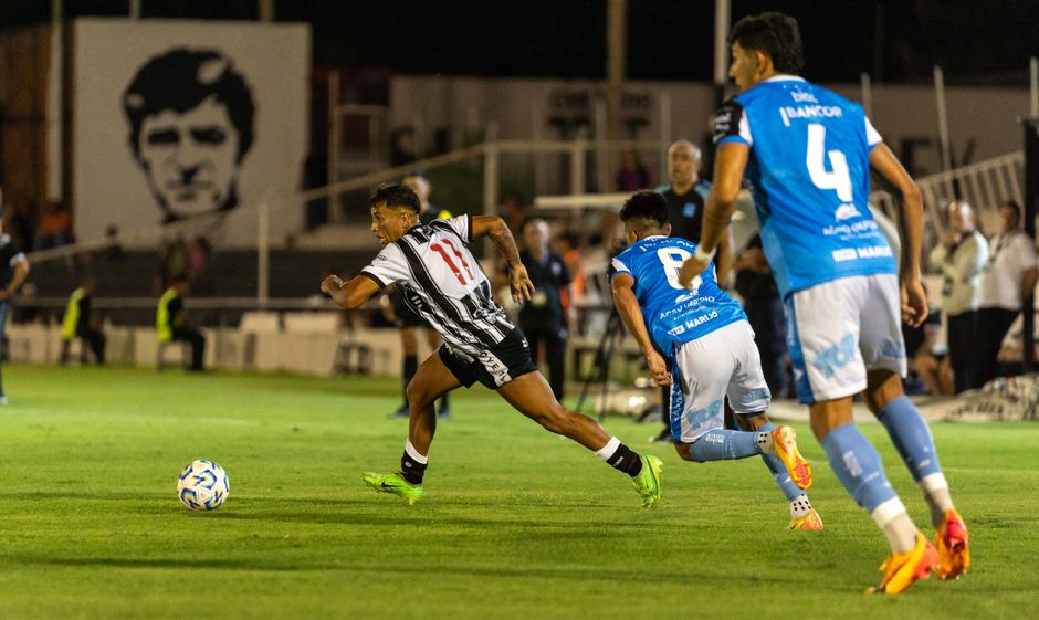 Dynamic moment in a soccer match with players in action during a night game on the field.
