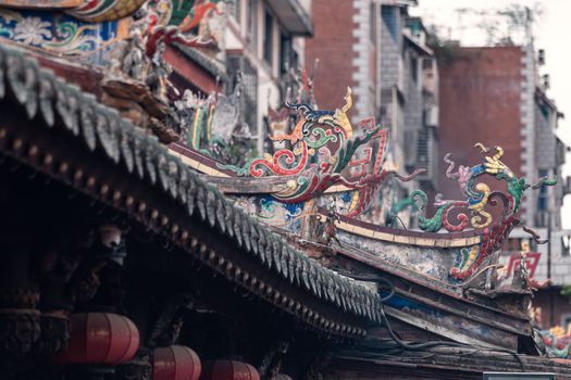 Detailed view of ornate traditional temple roof decorations in Zhangzhou, China.
