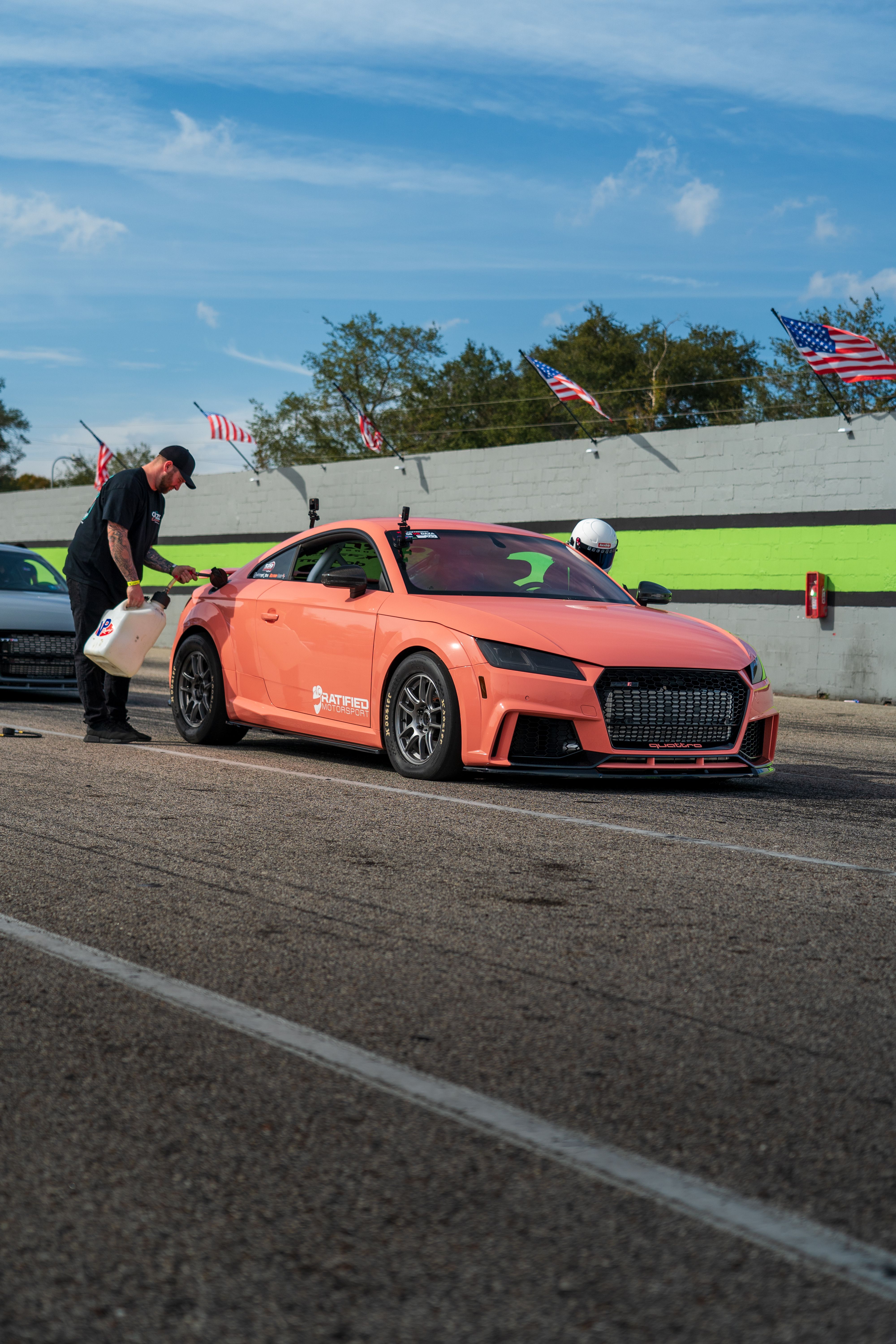 Sportscar in pit stop with team refueling on race day · Free Stock Photo